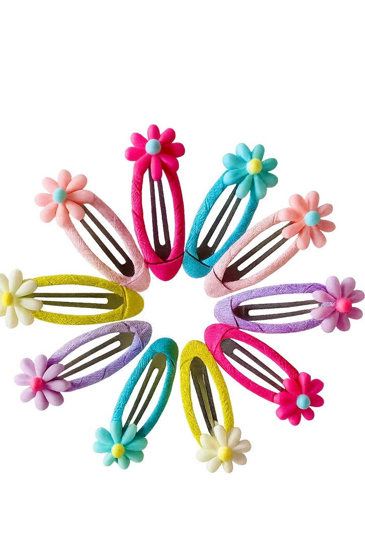Colorful hair clips with floral designs arranged in a circle on a white background