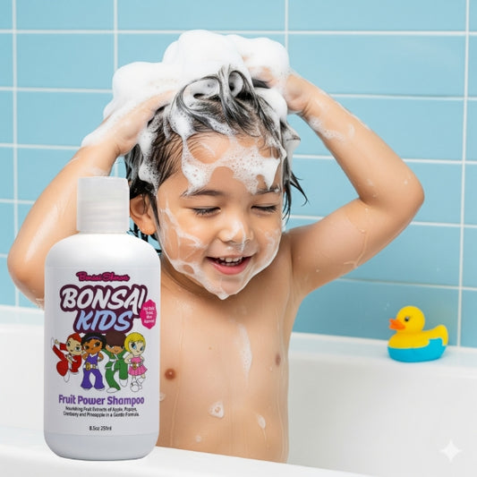 Child with shampoo on head next to a bottle of Bonsai Kids shampoo in a bathtub.