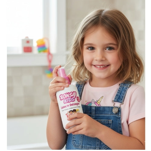 Young girl holding a bottle of Bona Kids cleaner in a room with colorful toys in the background